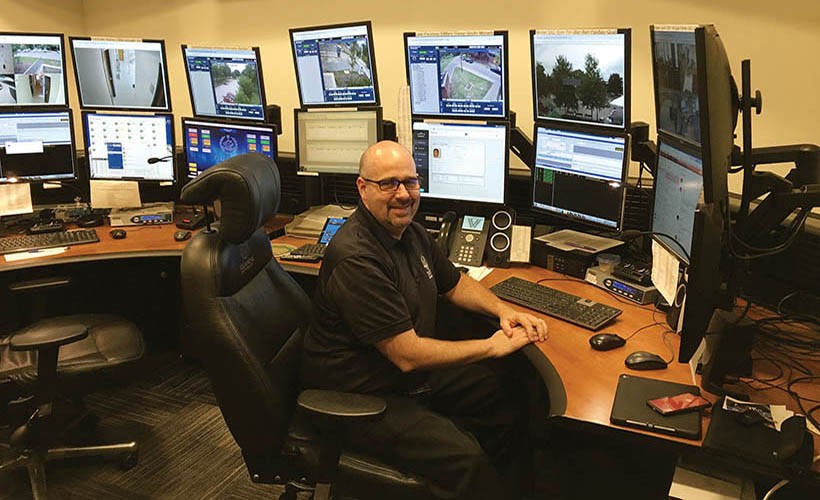 Uniformed Ӱԭ officer in Public Safety control room.